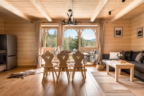 a living room with three chairs and a table at Wooden Chalet WRÓBLOWA CHAŁUPKA z balią przy Dolinie Chochołowskiej in Witów