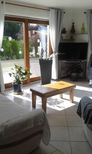 a living room with a coffee table and a tv at Propriete de 2 chambres avec terrasse et wifi a Liginiac a 5 km de la plage in Liginiac