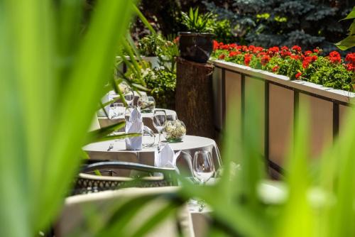 a row of tables with wine glasses on a balcony at Hotel Lamm in Naturno