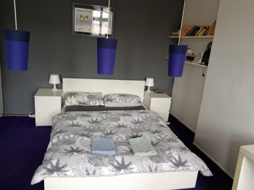 a bedroom with a bed with blue lights above it at Private bedroom near Alexanderplatz in Sharing Apartment in Berlin