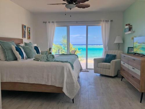 a bedroom with a bed and a view of the ocean at The Blue Iguana at Cottages in Sand Bluff