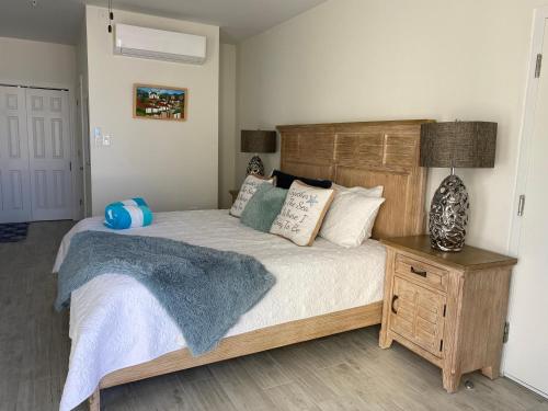 a bedroom with a large bed with a wooden headboard at The One Love at Cottages in Sand Bluff