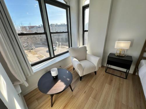 a room with a chair and a table and a window at Luxe Spacious SFH in Bucktown with Secure Parking in Chicago
