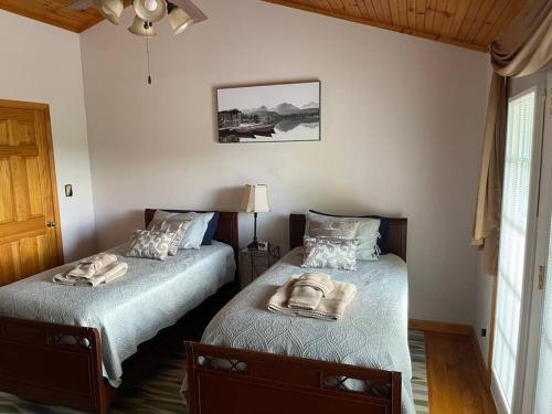 a bedroom with two beds with towels on them at Paradise Peak - Tranquility and majestic splendor! in Butler
