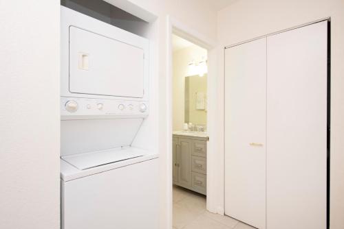 a kitchen with a white refrigerator and a sink at Snug Harbour View Condo #3 in George Town