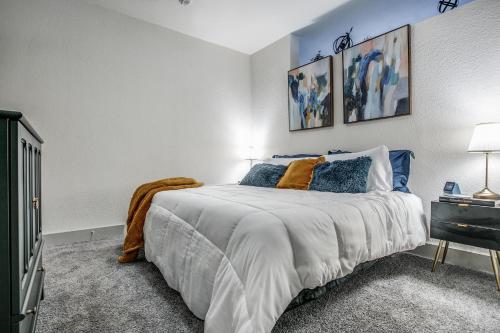 a bedroom with a large bed with blue pillows at Modern Luxury Condo on Riverwalk #1335 in San Antonio