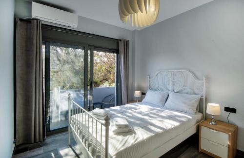 a bedroom with a bed and a large window at E&A luxury apartment with sea view in Rhodes Town