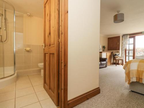 a bathroom with a shower and a toilet at The Kilns in St Austell