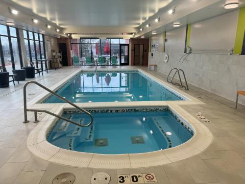 a pool in a building with a swimming pool at Home2 Suites by Hilton Salt Lake City/Layton in Layton