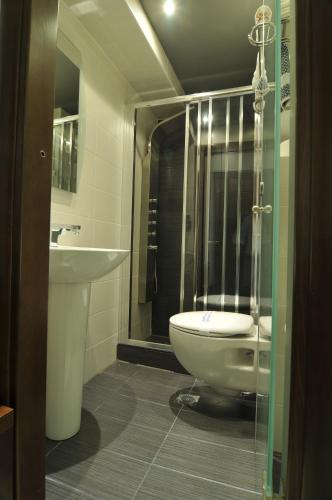 a bathroom with a toilet and a sink at Panorama Inn Hotel in Paralia Katerinis
