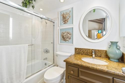a bathroom with a sink and a toilet and a mirror at 2 Bedroom Home on the Beach with Ocean View in Newport Beach