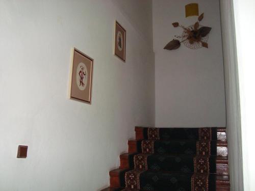 a room with a staircase with pictures on the wall at Penzion Adria in Turčianske Teplice