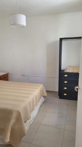 a bedroom with a bed and a dresser in it at Lo de tungo in Paraná