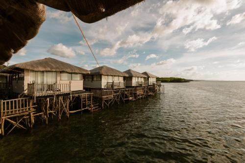 a row of houses on a dock in the water at Kaway Resort & Spa in Tabuelan