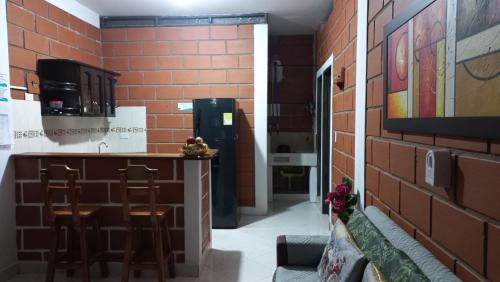 a bar in a room with a brick wall at Cabañas Mar Caribe in Necoclí