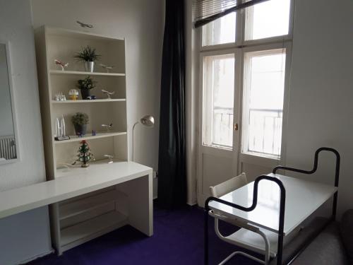 a bathroom with a white desk and a window at Private bedroom near Alexanderplatz in Sharing Apartment in Berlin