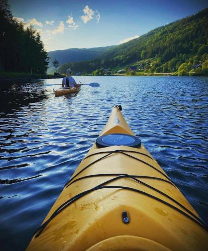 a man is in a kayak on a lake at Bjørkli Lodge in Geilo