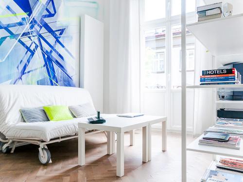 a living room with a white couch and a table at Boom Apartments in Kraków