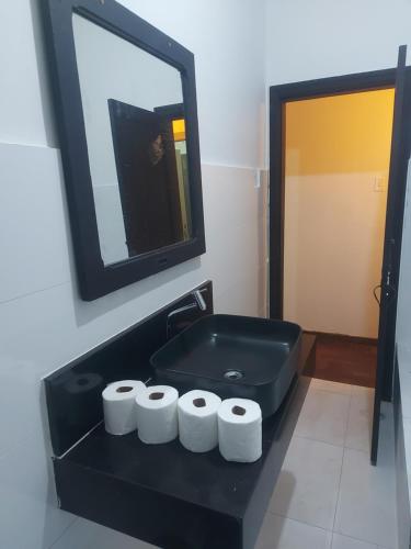 a bathroom with a black sink and a mirror at Pousada Seu Souza in Belo Horizonte