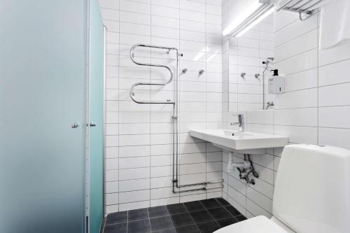 a bathroom with a sink and a toilet and a shower at Best Western Plus Skogshöjd in Södertälje
