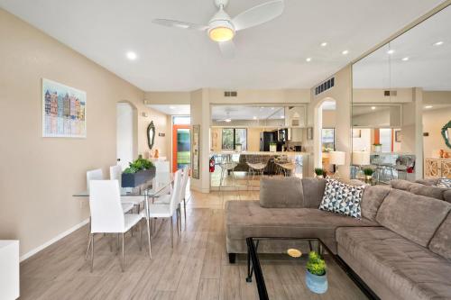 a living room and dining room with a couch and a table at Midnights at the Oasis in Cathedral City