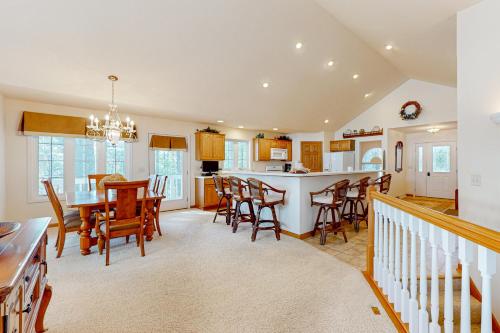 a kitchen and living room with a table and chairs at Yellow Birch Memories in Eagle River