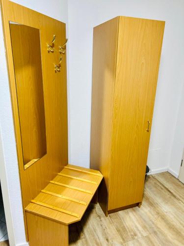 a wooden closet with a wooden shelf next to a door at Pension Maria in Rochlitz