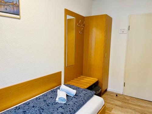 a bedroom with a bed with two towels on it at Pension Maria in Rochlitz