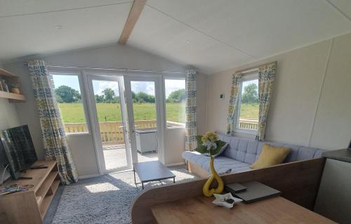 a living room with a couch and a table at Little Vatson in Pembrokeshire