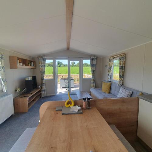 a living room with a table and a couch at Little Vatson in Pembrokeshire