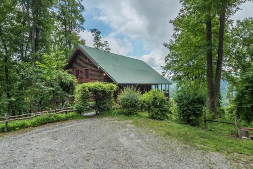a barn with a gravel road in front of a house at Shadow Ridge Retreat Pet Friendly and Views in Fletcher
