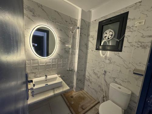 a bathroom with a toilet and a sink and a mirror at Montazah seaside homes in Sharm El Sheikh