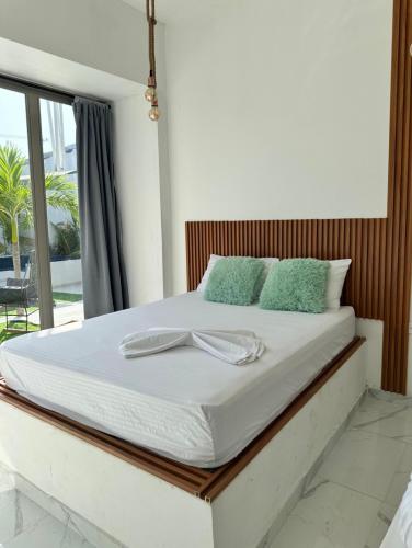 a white bed with a bow on top of it at Hotel Casa Cafur in Santa Ana