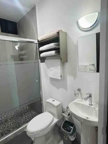 a small bathroom with a toilet and a sink at Loft Marina Cerritos in Mazatlán