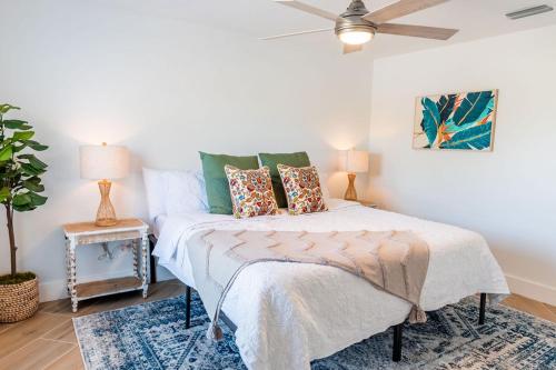 a bedroom with a bed and a ceiling fan at Stunning! Barefoot Breeze - Sale! New Waterfront Listing! Brand New Pool with Putting Green! in Bonita Springs