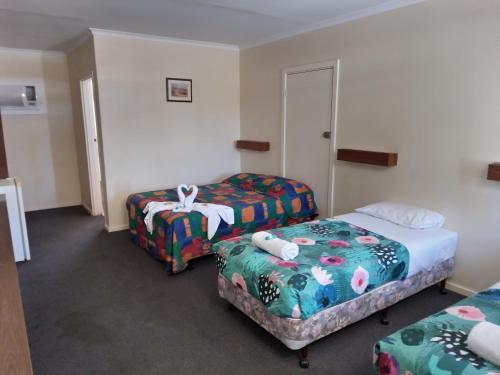 a hotel room with two beds at Austral Inn in Quorn