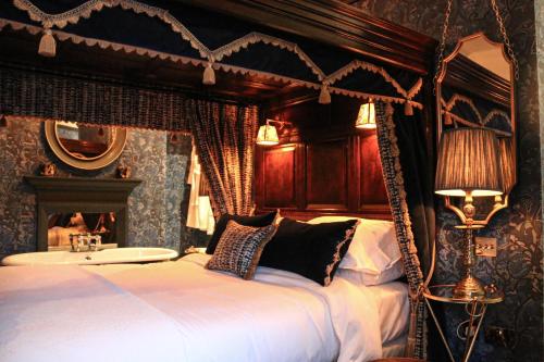 a bedroom with a bed with a canopy at HIGHFIELD in Great Driffield