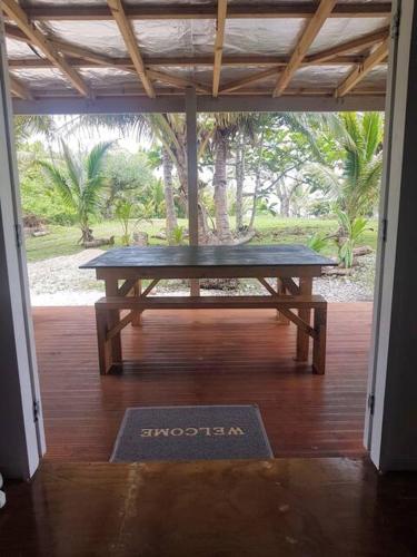 a picnic table in the middle of a porch at Kaina Kaute in Alofi