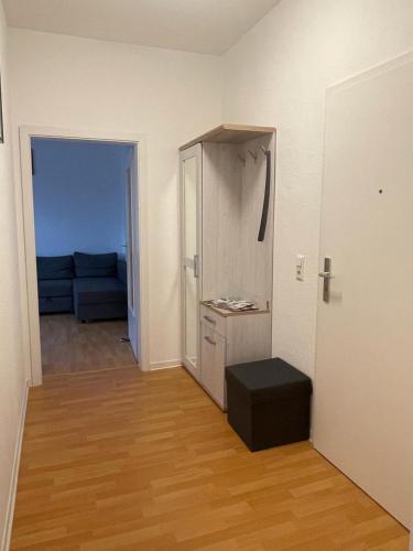 a living room with a room with a couch and a table at A&A Apartments in Chemnitz