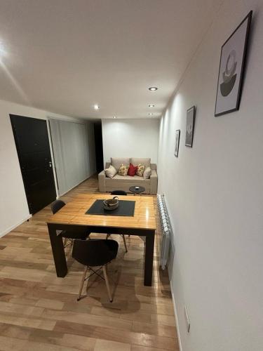 a living room with a table and a couch at Complejo Del Este Suites in San Carlos de Bariloche