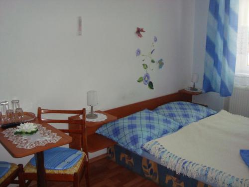 a bedroom with two twin beds and a table at Penzion Adria in Turčianske Teplice