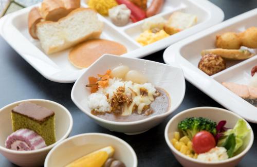 a group of bowls of food on a table at SARASA HOTEL Namba in Osaka