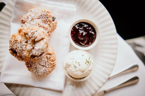 a plate with two pastries and a cup of sauce at HIGHFIELD in Great Driffield