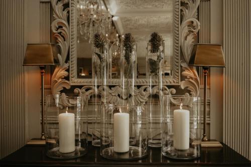 a table with candles on it with a mirror at HIGHFIELD in Great Driffield