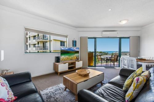 a living room with a couch and a table at Sunshine Towers Boutique Apartments in Maroochydore