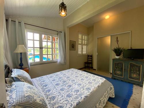 Ένα ή περισσότερα κρεβάτια σε δωμάτιο στο Pousada Villa Provence