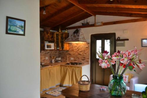a kitchen with a vase of flowers on a table at One bedroom chalet with terrace and wifi at Hermigua 3 km away from the beach in Hermigua