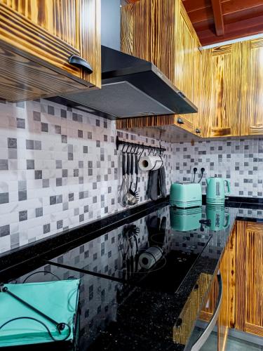 a kitchen with a glass counter top with a stove at Laura's Cottage AL in Velas