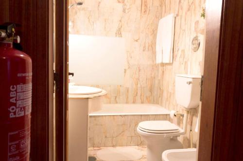 a bathroom with a toilet and a sink and a tub at One bedroom appartement at Vila Nova de Gaia 100 m away from the beach with wifi in Vila Nova de Gaia