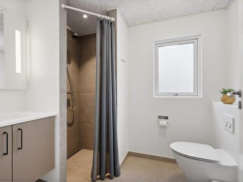 a bathroom with a toilet and a shower at Holiday home Henne VI in Henne Strand